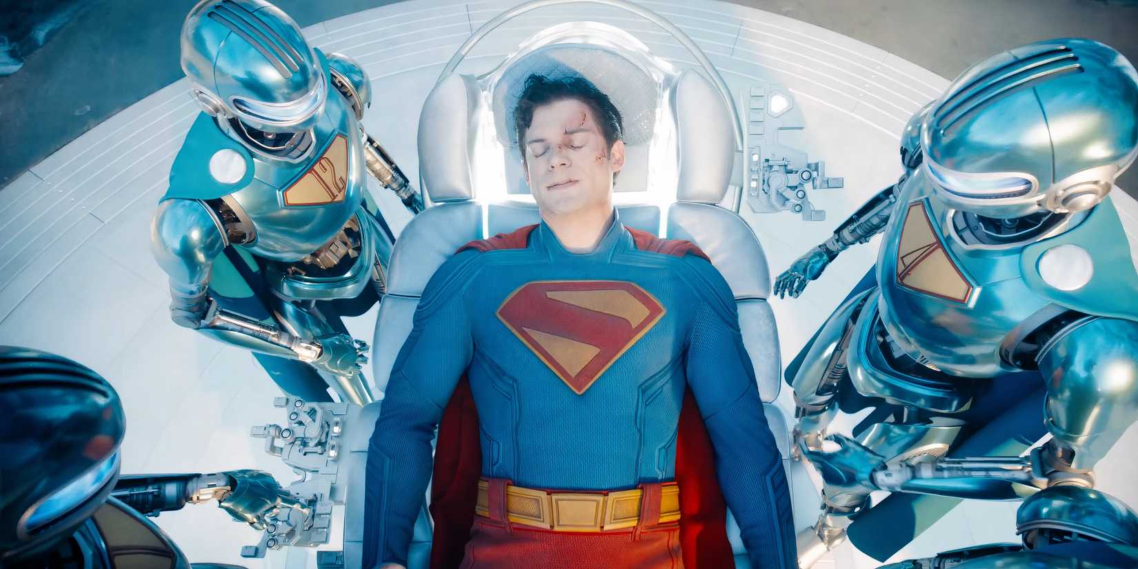 The Superman Robots tending to an injured Superman in James Gunn's Superman