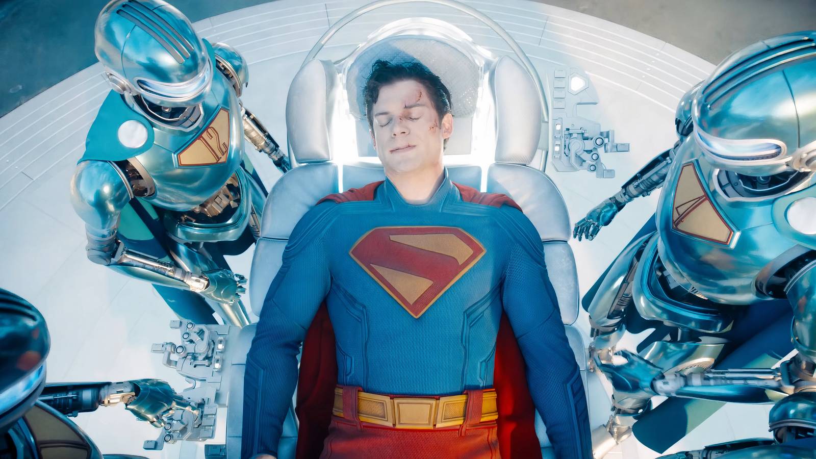 The Superman Robots tending to an injured Superman in James Gunn's Superman