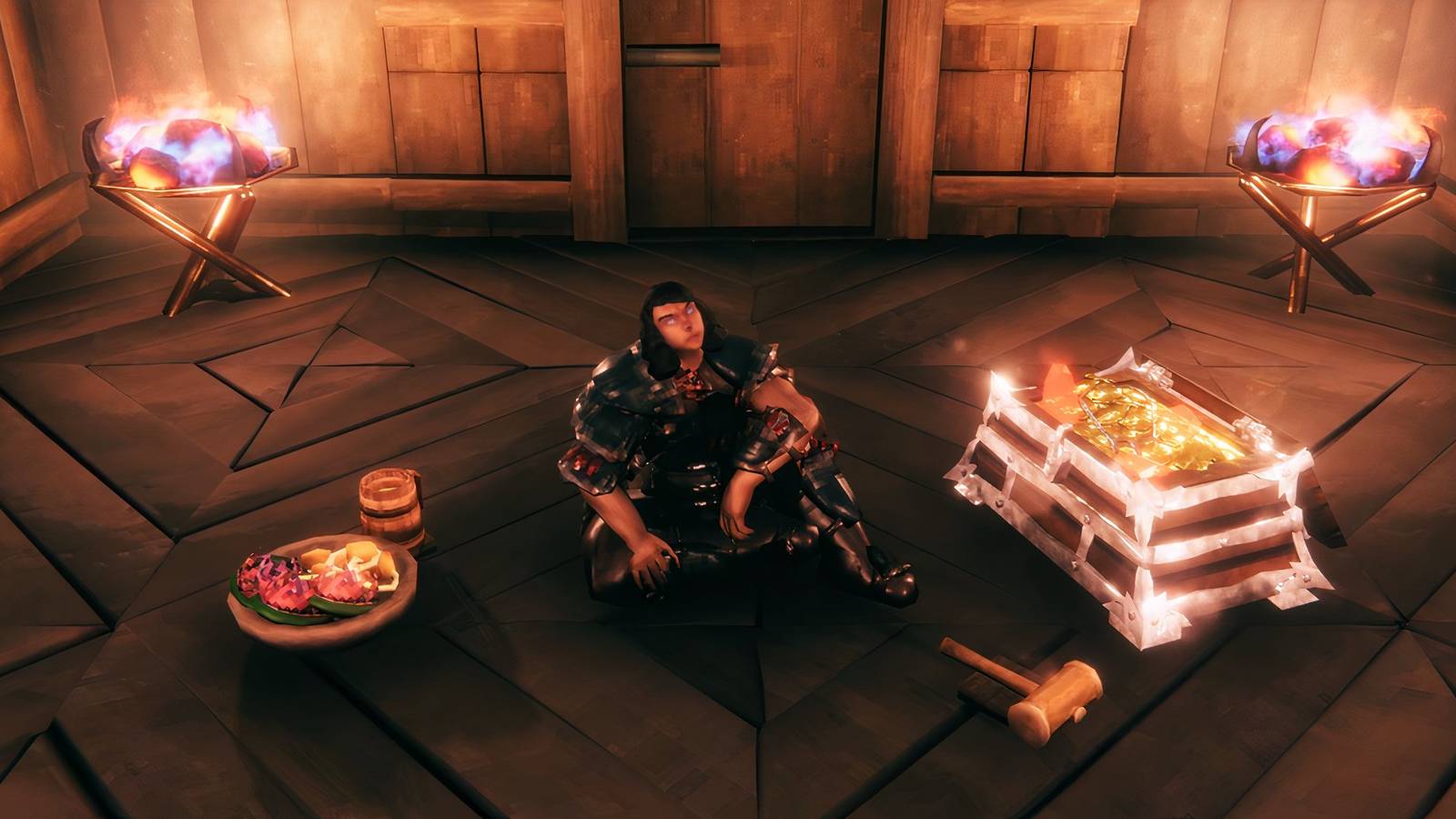 Valheim player sitting in home base with food and treasure chest