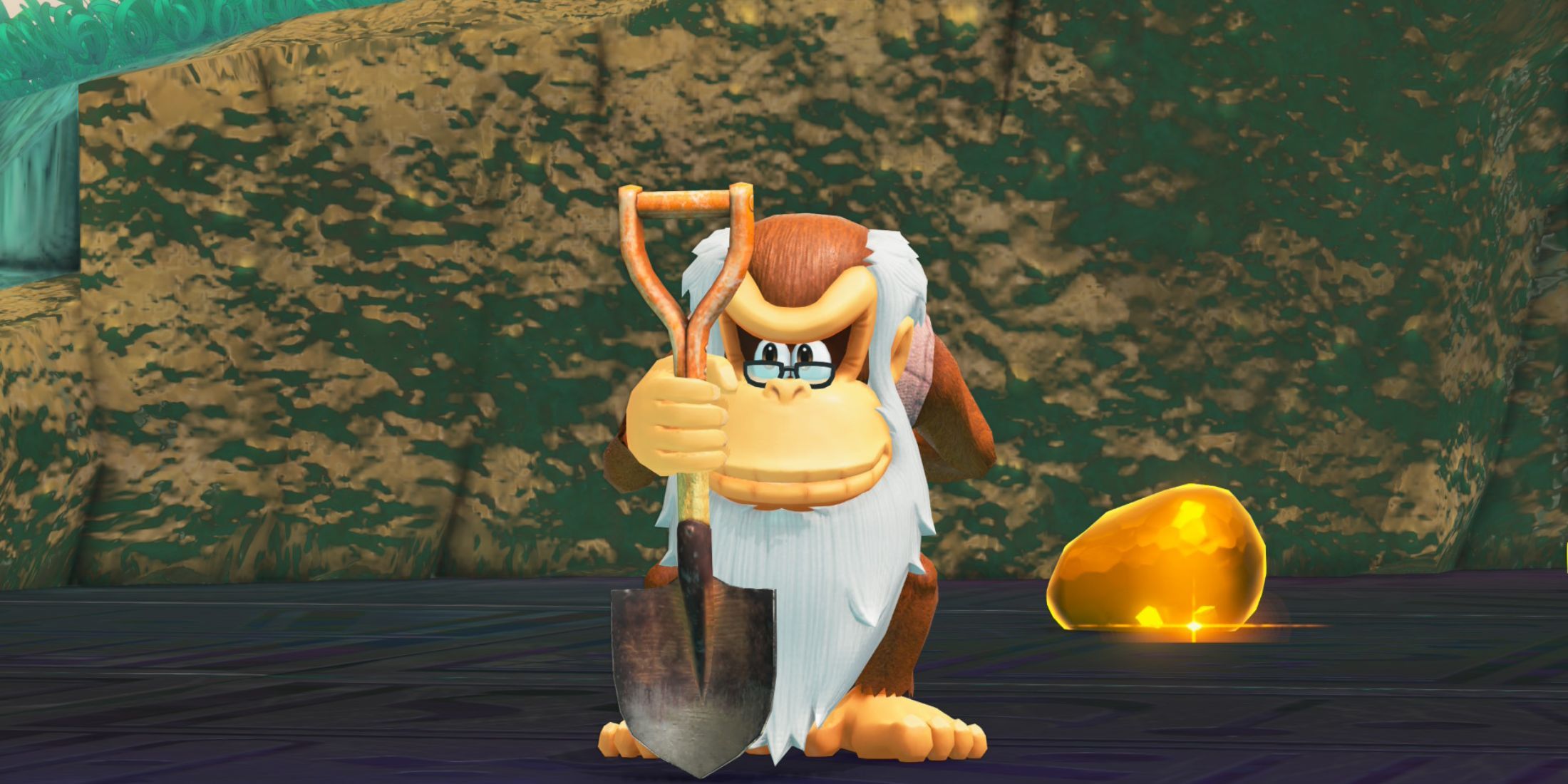 Cranky Kong holding a shovel next to a glowing gold gem in Donkey Kong Bananza