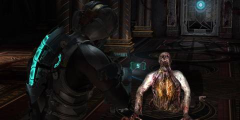 Isaac Clarke fighting some Necromorphs in Dead Space 2.