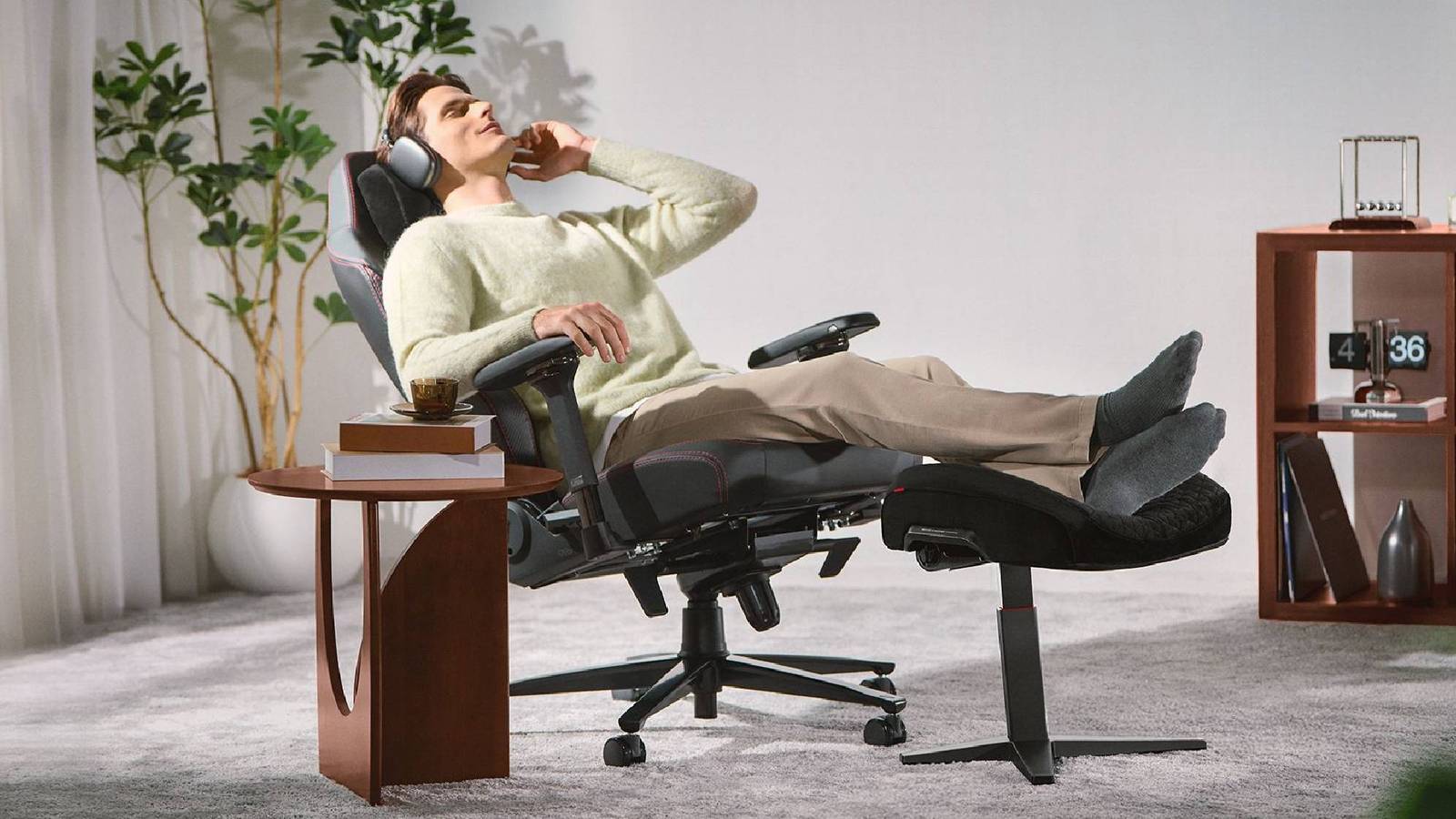 Promotional image of the Secrelab Otto Adjustable Legrest being used by a man