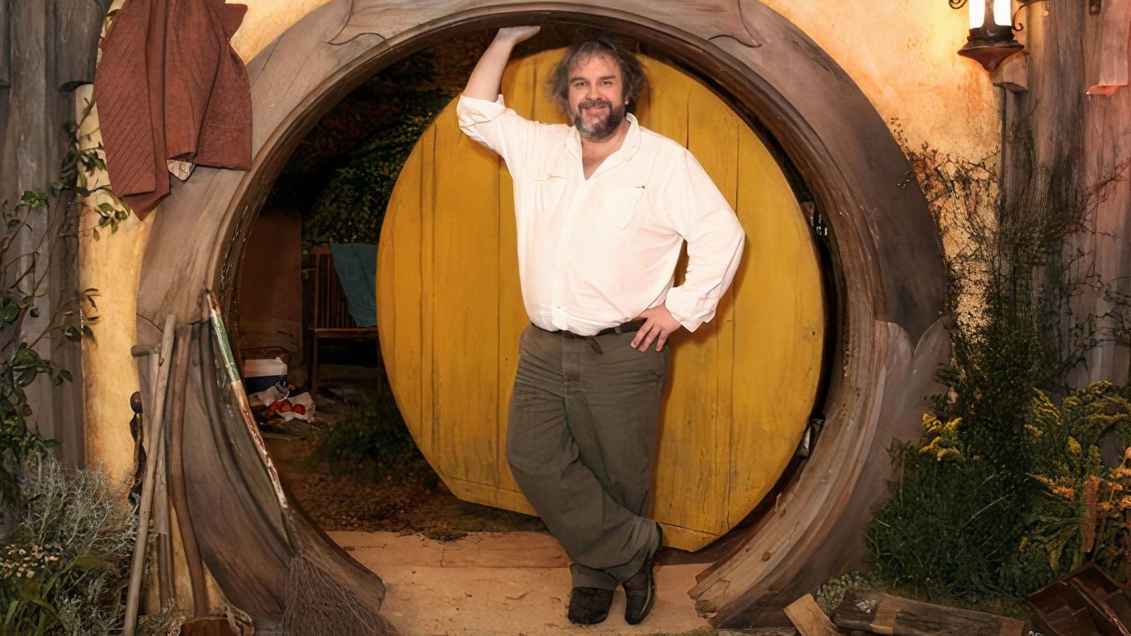 Peter Jackson standing outside a Hobbit home