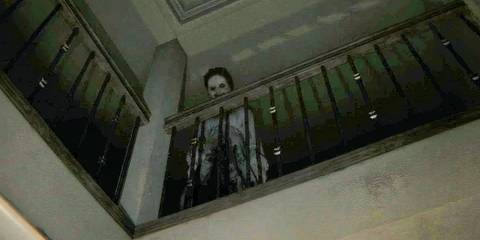 Lisa looking over a stairs balcony