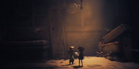 Two characters looking at a map in Little Nightmares 3