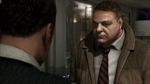 A detective speaking with another man in Heavy Rain