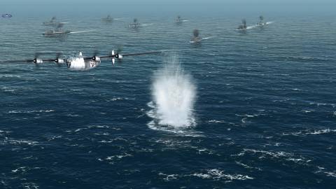 A plane flying past a fleet of ships in Atlantic Fleet