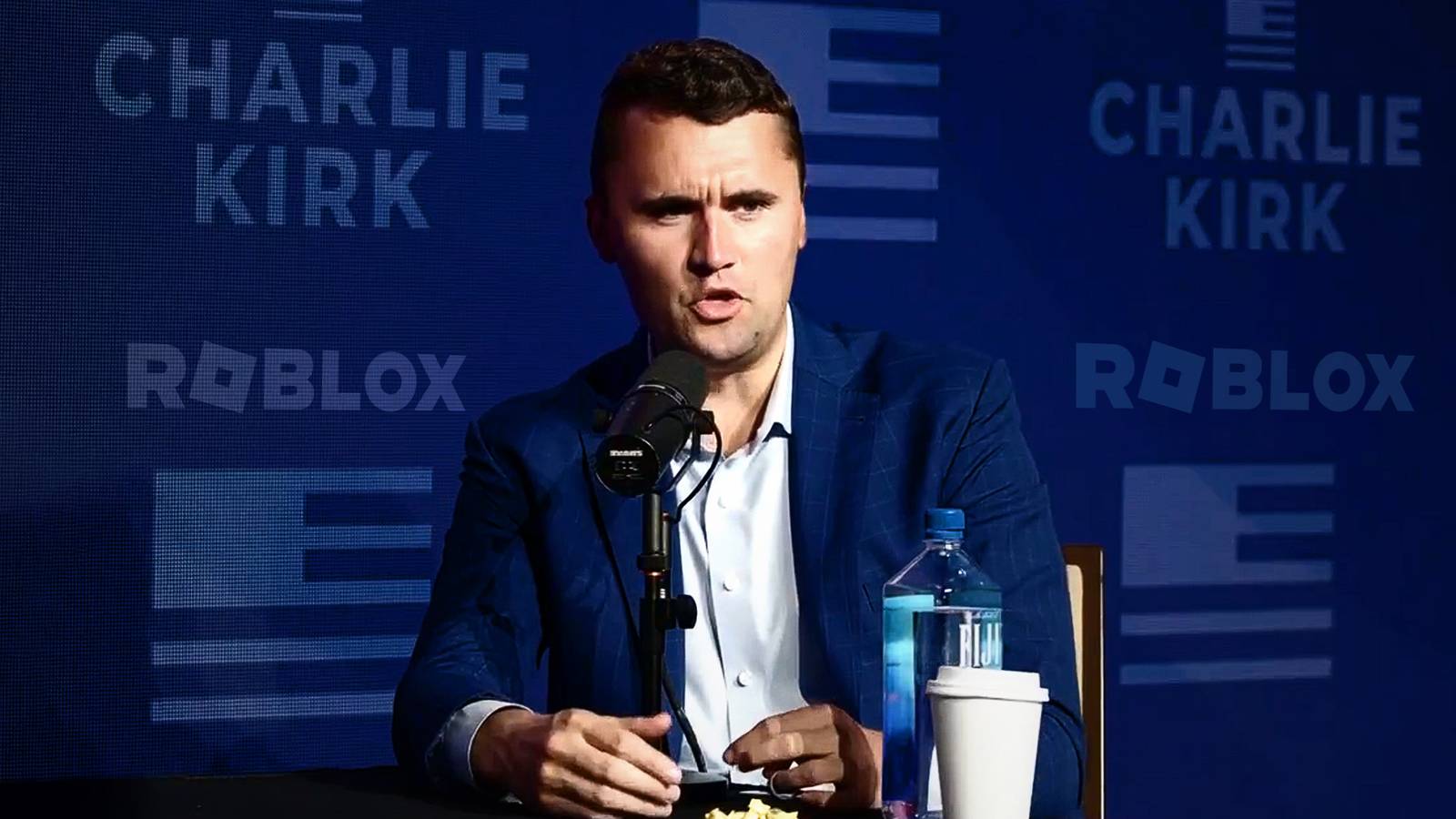 Charlie Kirk press conference blue background with Roblox logo 16x9 composite