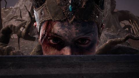Senua with a sword in front of her face