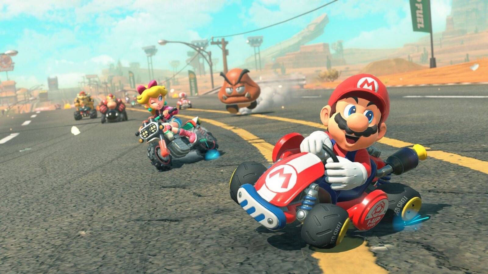 Mario and Peaching driving their karts in Mario Kart World.