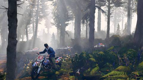Trevor driving a bike in the woods in Grand Theft Auto 5