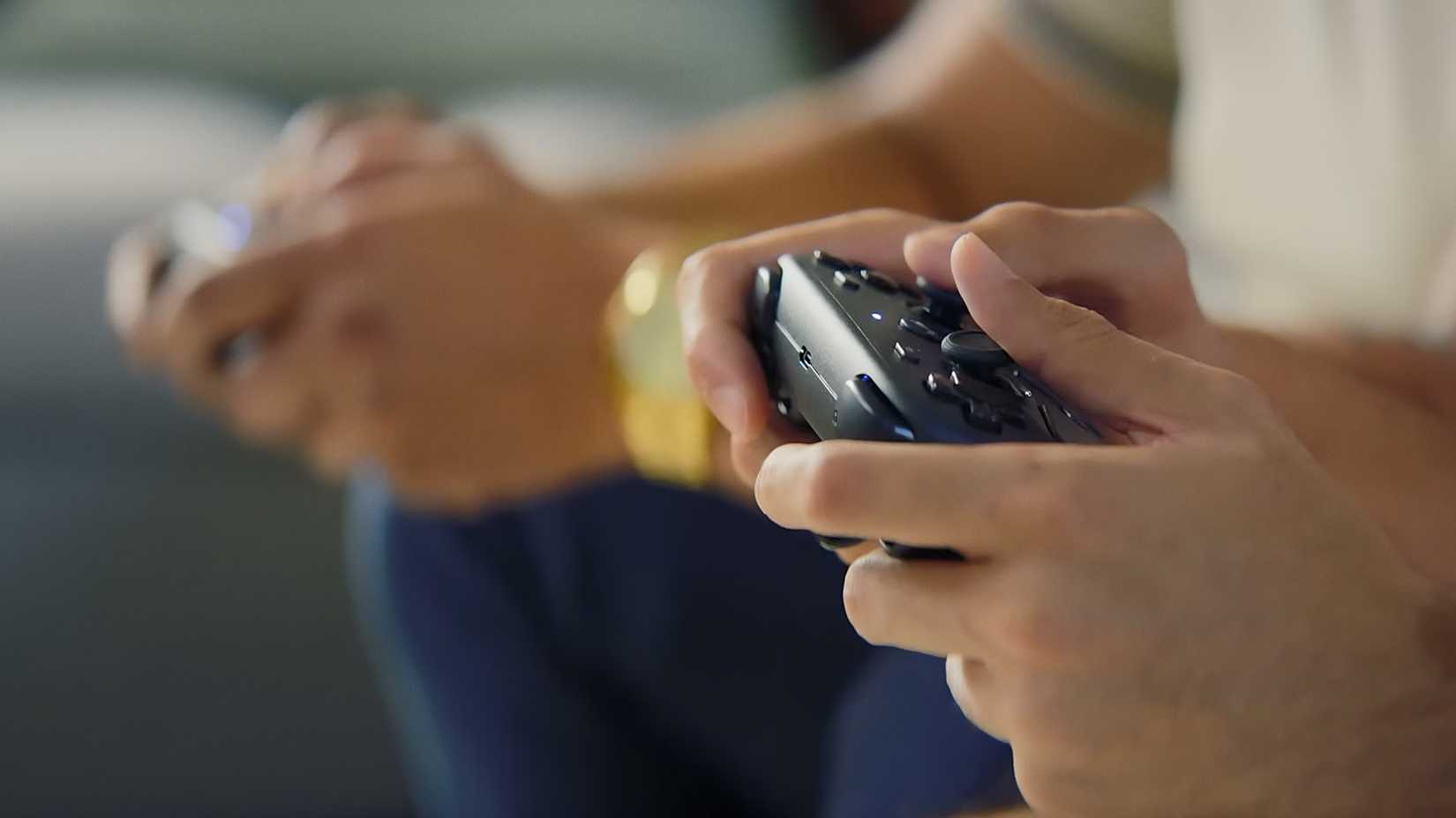 Image of two people using Steam Controllers