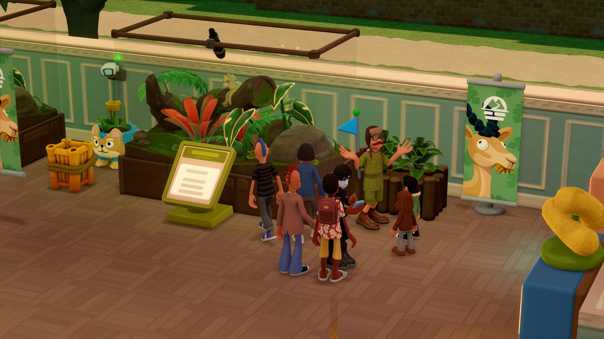 A tour in front of a small terrarium in Two Point Museum Zooseum