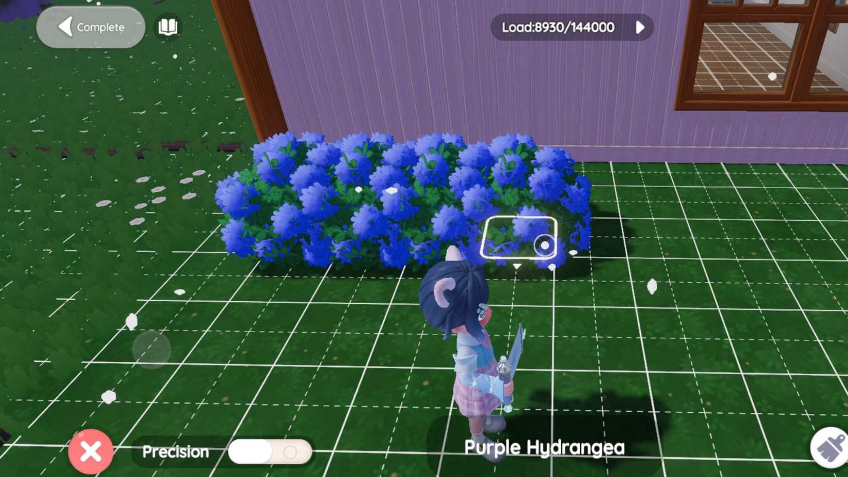 A player placing blue hydrangeas close together to form a large bush in Heartopia