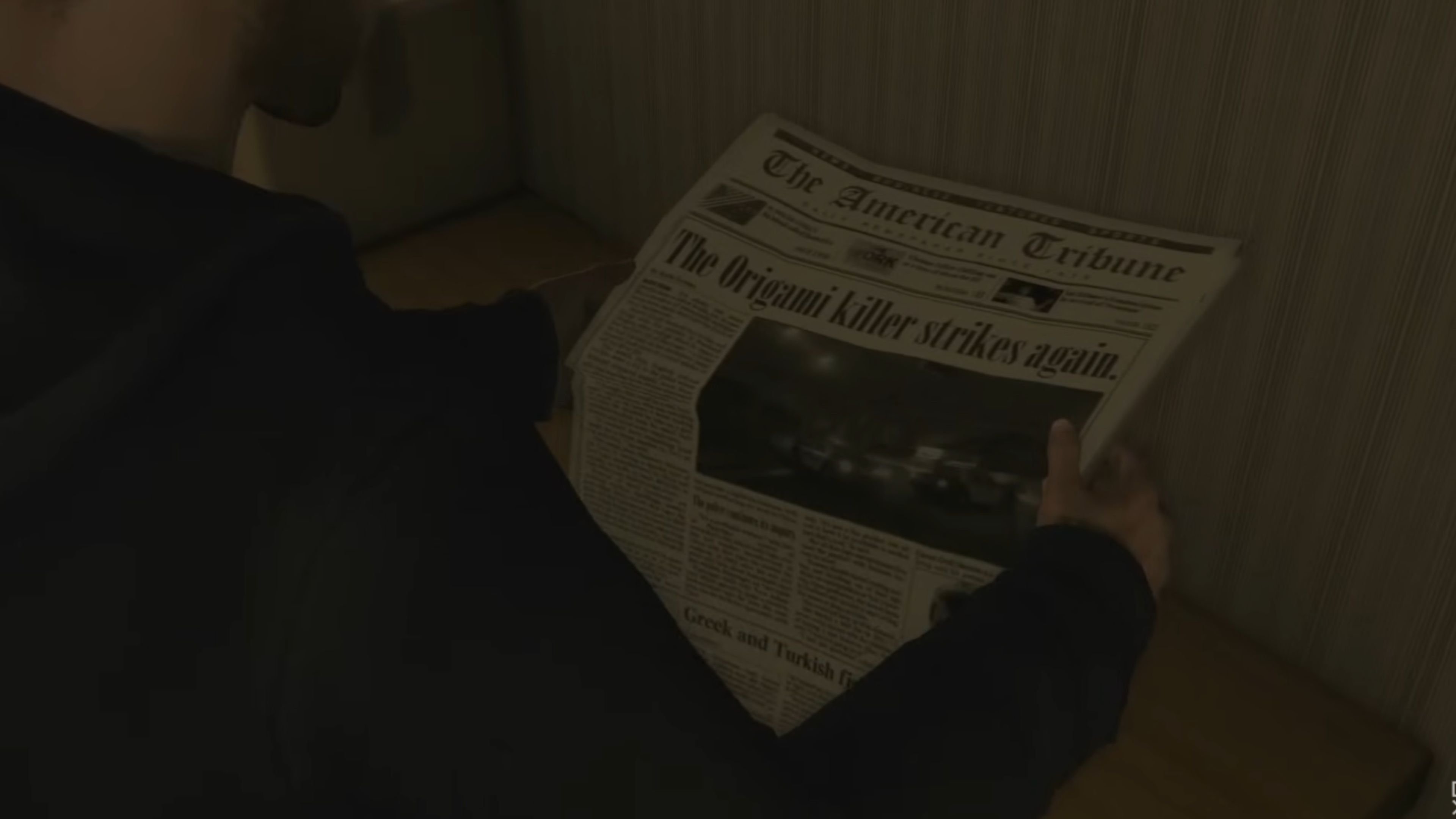 Reading a Newspaper of the Origami Killer in Heavy Rain
