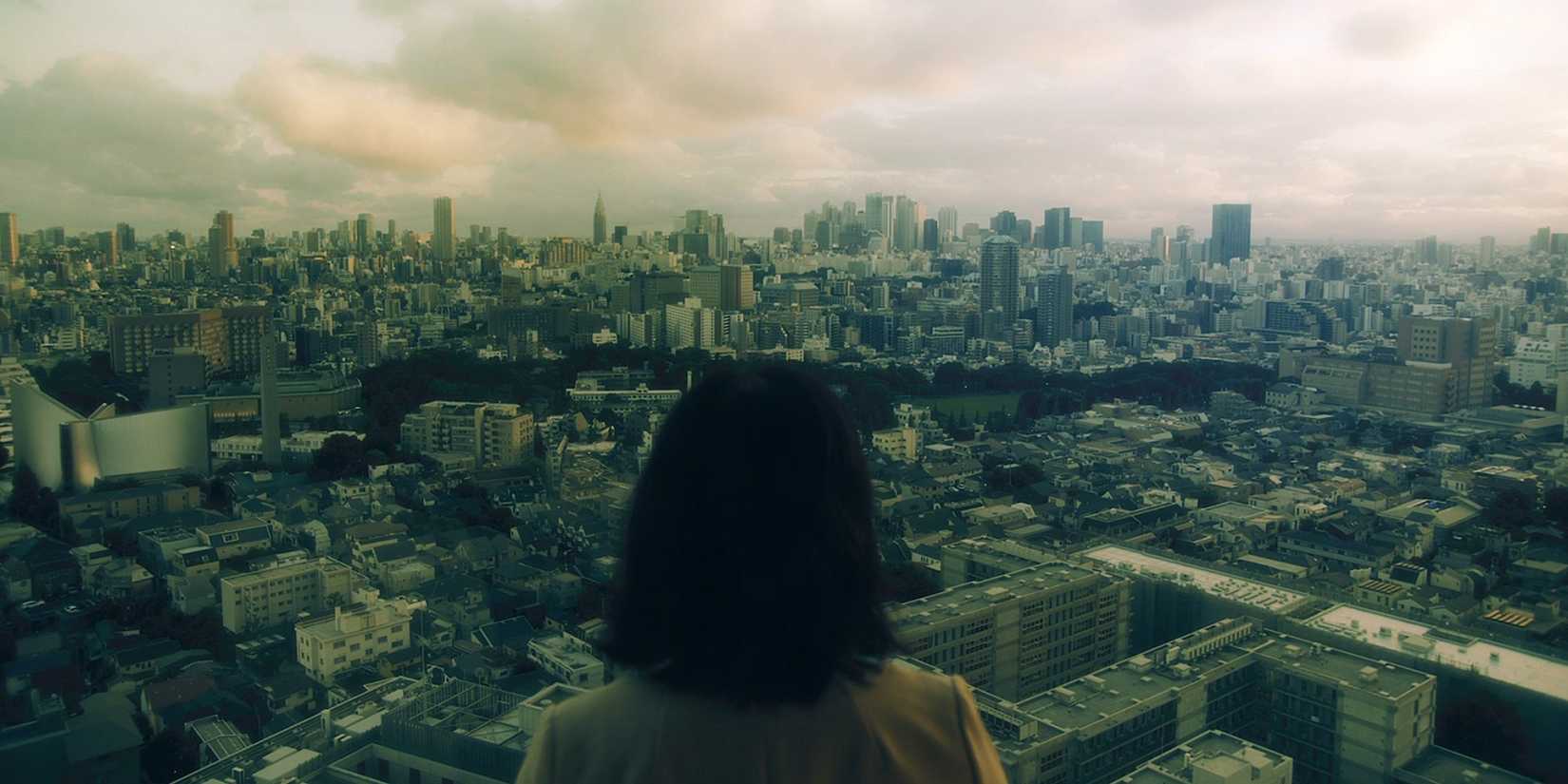 A woman looking out over the Tokyo metropolis.
