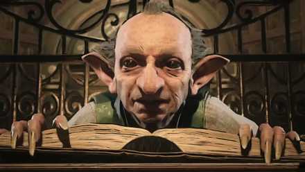 A Hogwarts goblin bends over a book