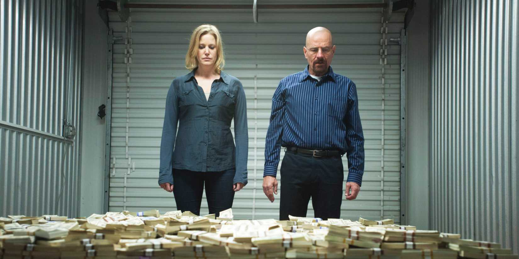 Skylar White and Walter White stare at stacks of money in a storage shed in Breaking Bad.
