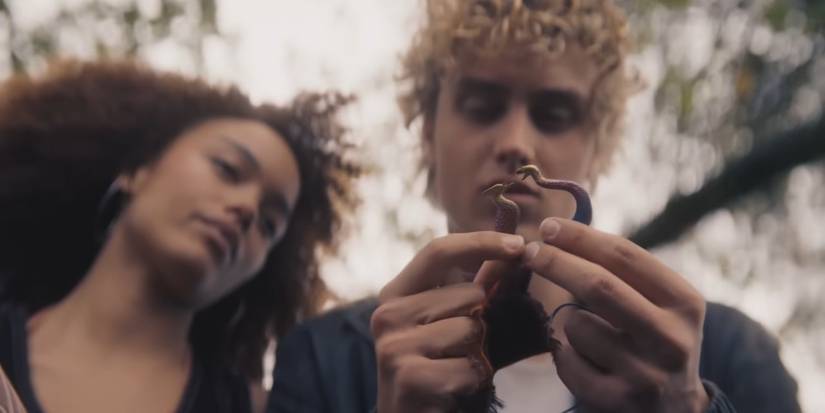 Haymitch and Lenore Dove look down at the firestriker in Haymitch's hands in Sunrise on the Reaping