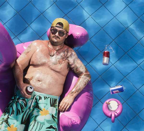 A man lays on a floaty in a pool in GTA 6