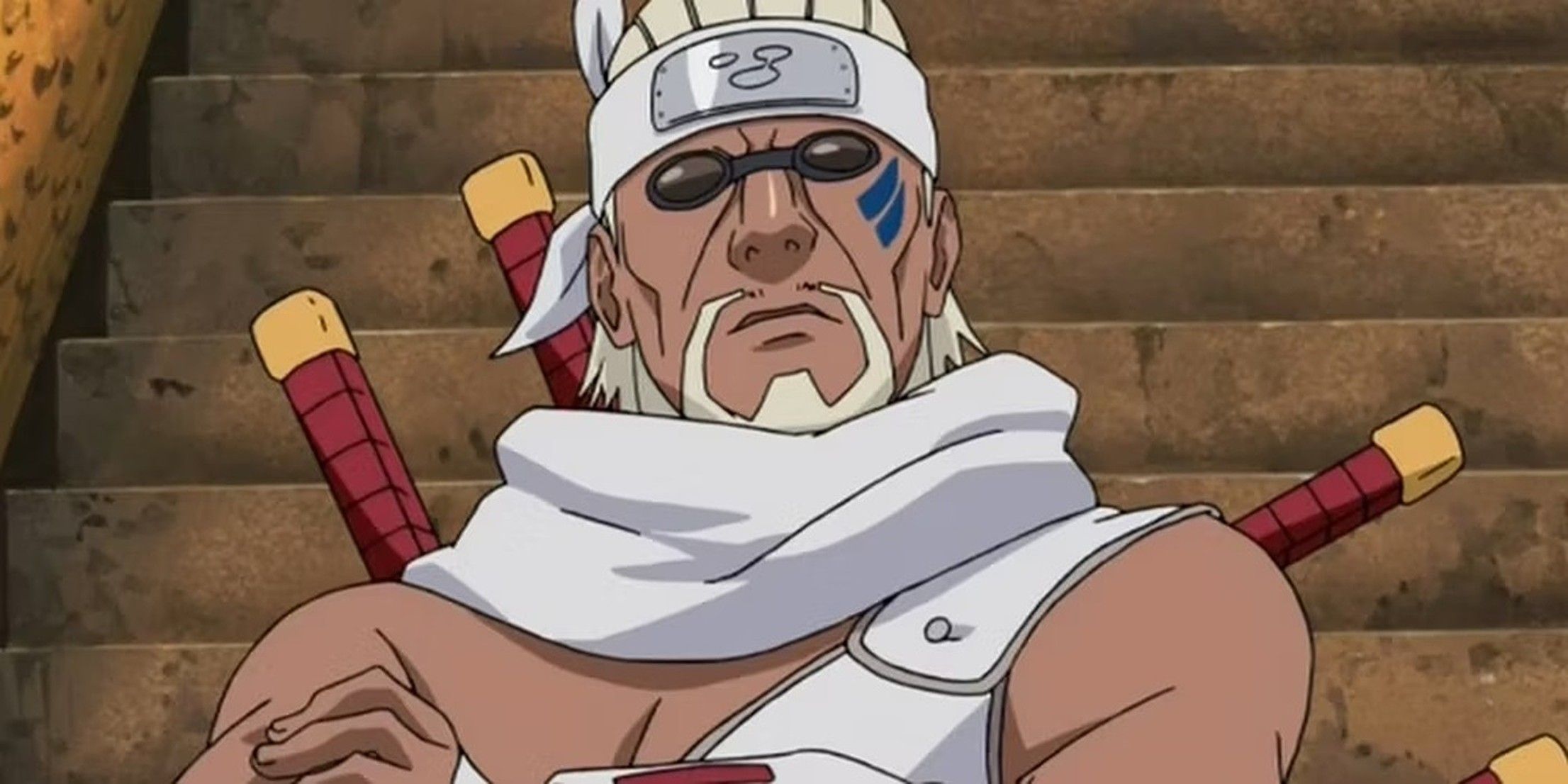 Killer Bee folds his arms in front of the stairs.