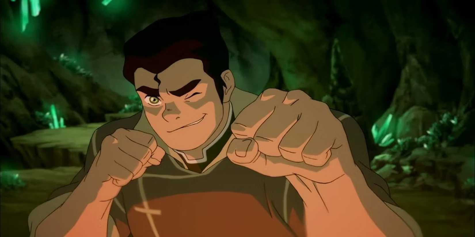 Bolin winks while raising his fists in a cave.