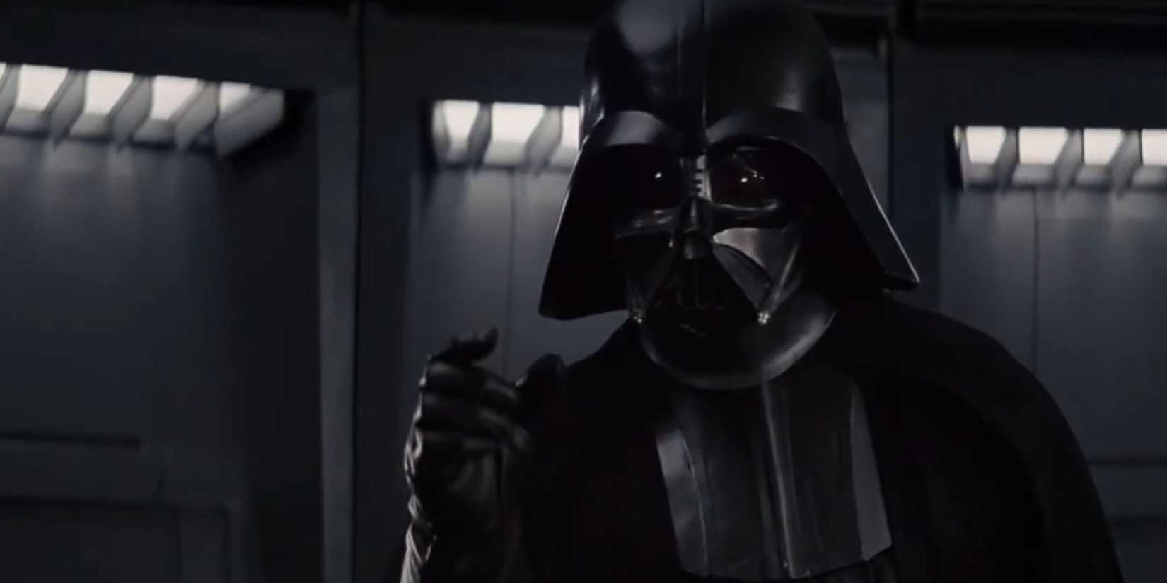 Darth Vader gör en gest i mötesrummet.