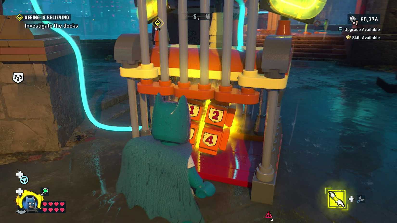 Batman examines the Cluemaster Puzzle Box in LEGO Batman Legacy of the Dark Knight