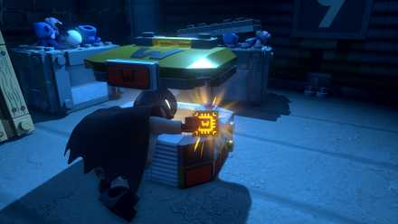 Batman collecting a glowing WayneTech Chip in LEGO Batman Legacy of the Dark Knight
