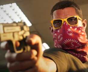 gta 6 protagonist jason duval pointing a gun at the camera.