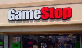 A GameStop storefront during normal business hours, with advertisements for several games and consoles.