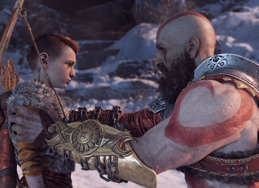 Kratos holding Atreus by the shoulders in God of War 2018