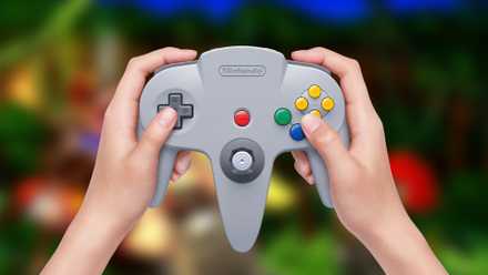 n64 controller being held with donkey kong 64 blurred in the background