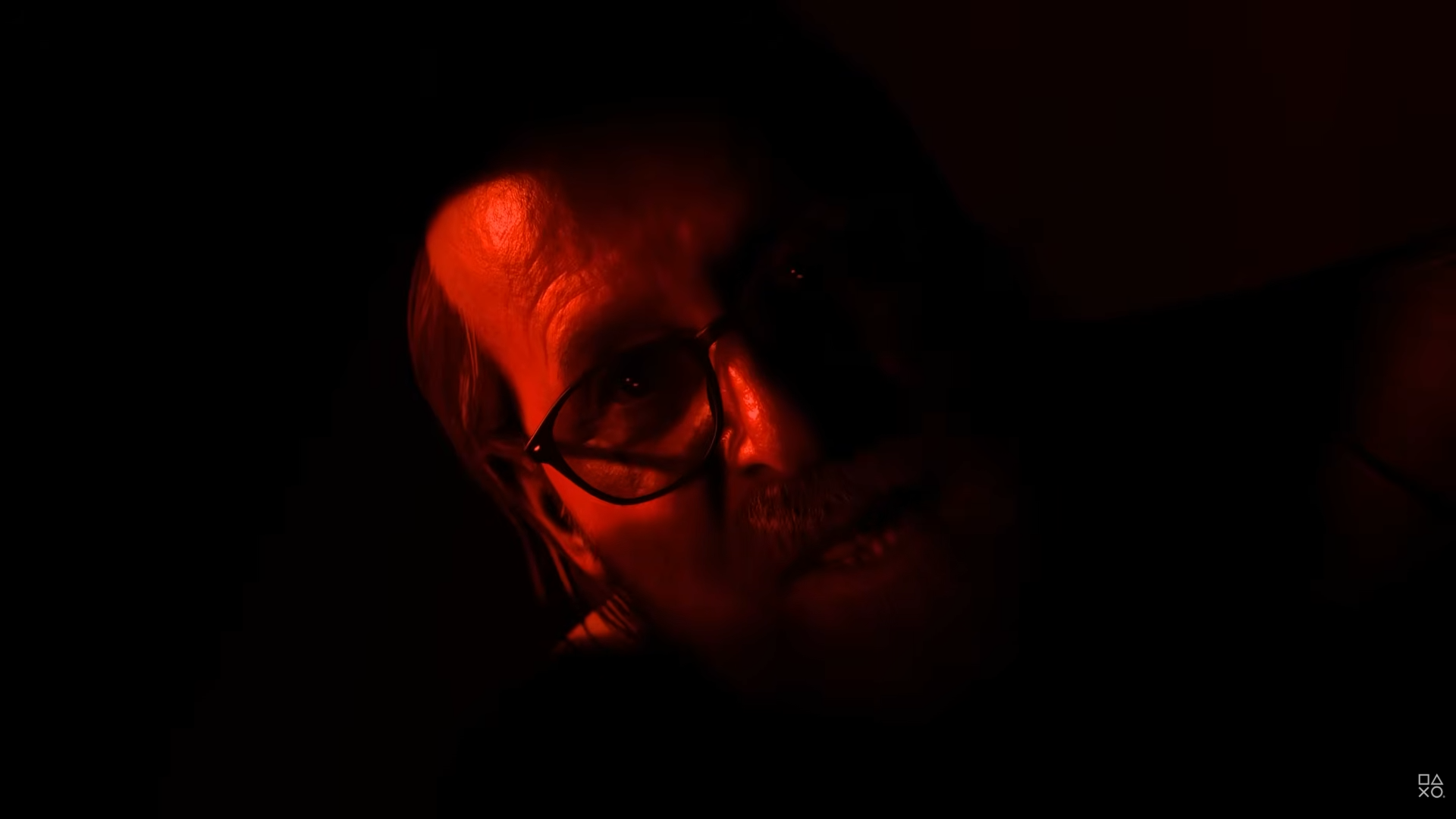 Dr Hill from Until Dawn in red light speaking to the player of the game.