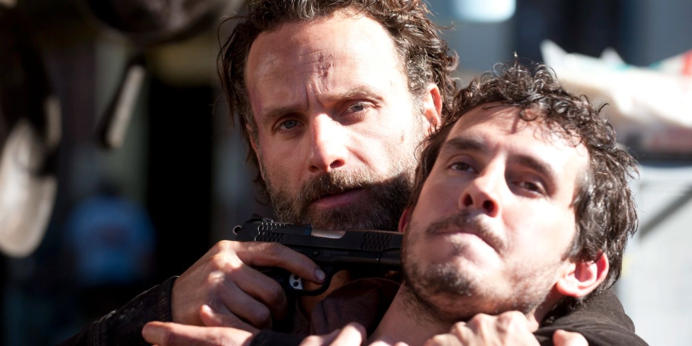 Rick Grimes with a gun to someone's head in The Walking Dead