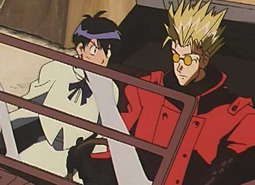Vash and Meryl driving as the woman reprimands him.