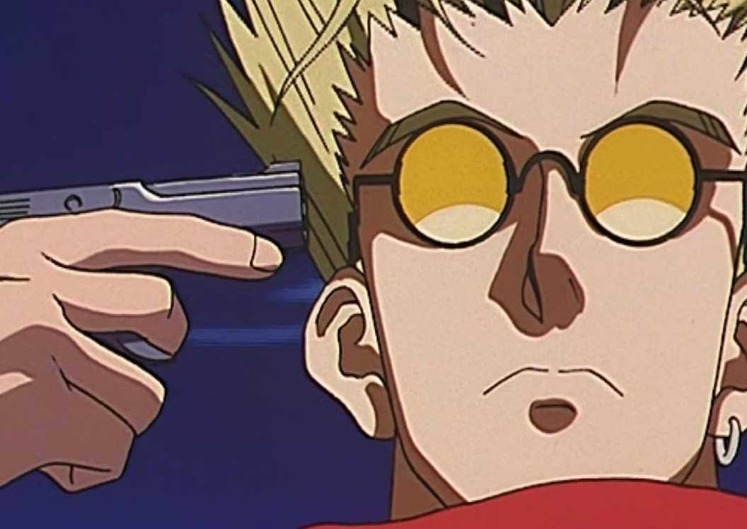 Vash pointing a gun at himself as he stares down at the human traffickers.