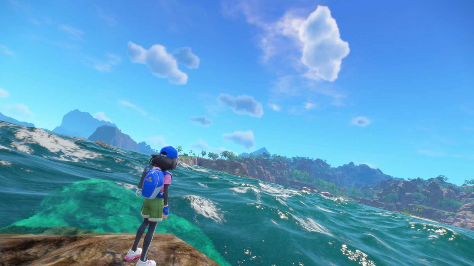 Pokemon Winds and Waves trainer staring out at roaring waves