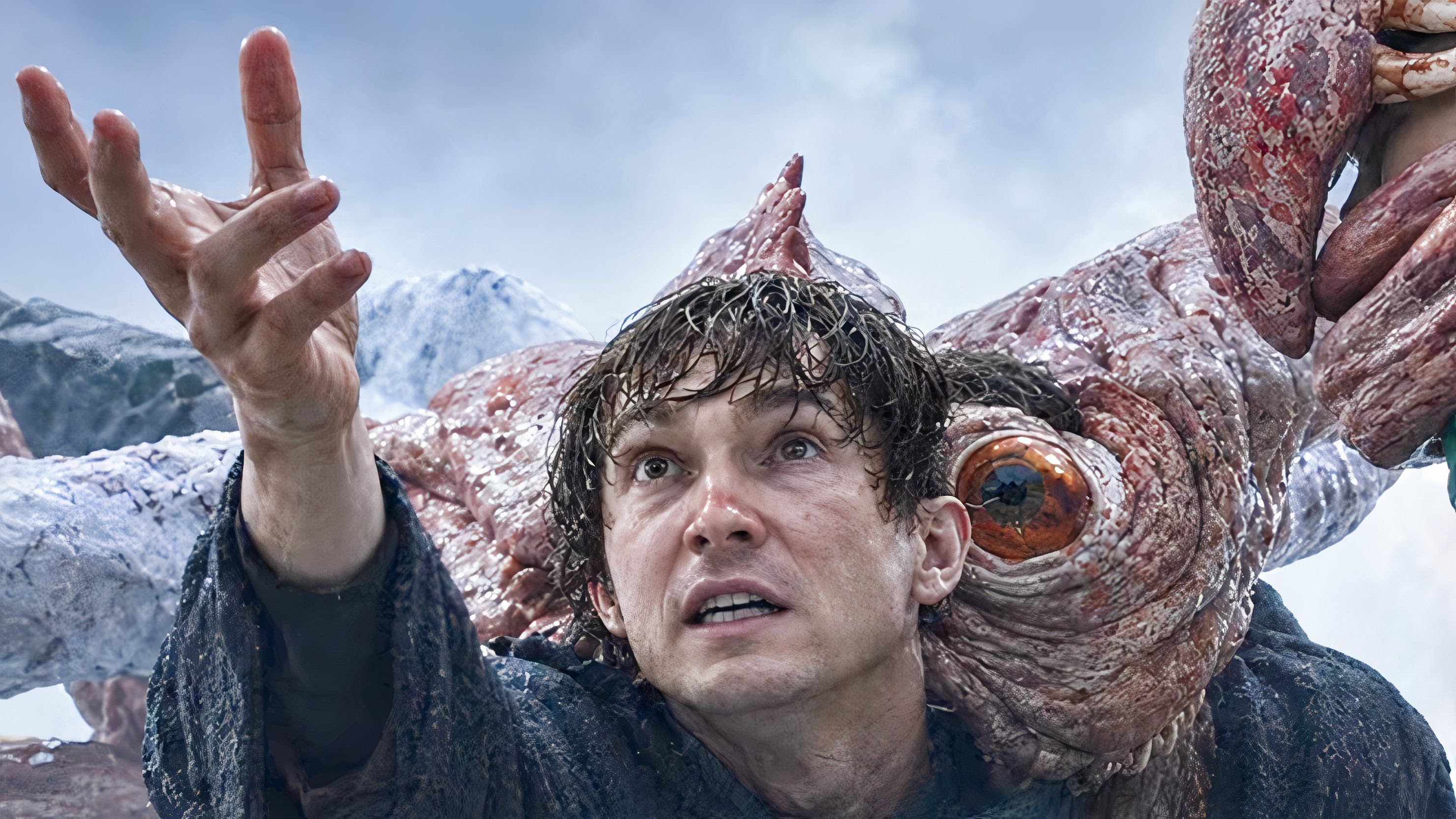 Austin Abrams as Bryan, mutating into a multi-eyed monster from a virus infection, reaching out to someone offscreen