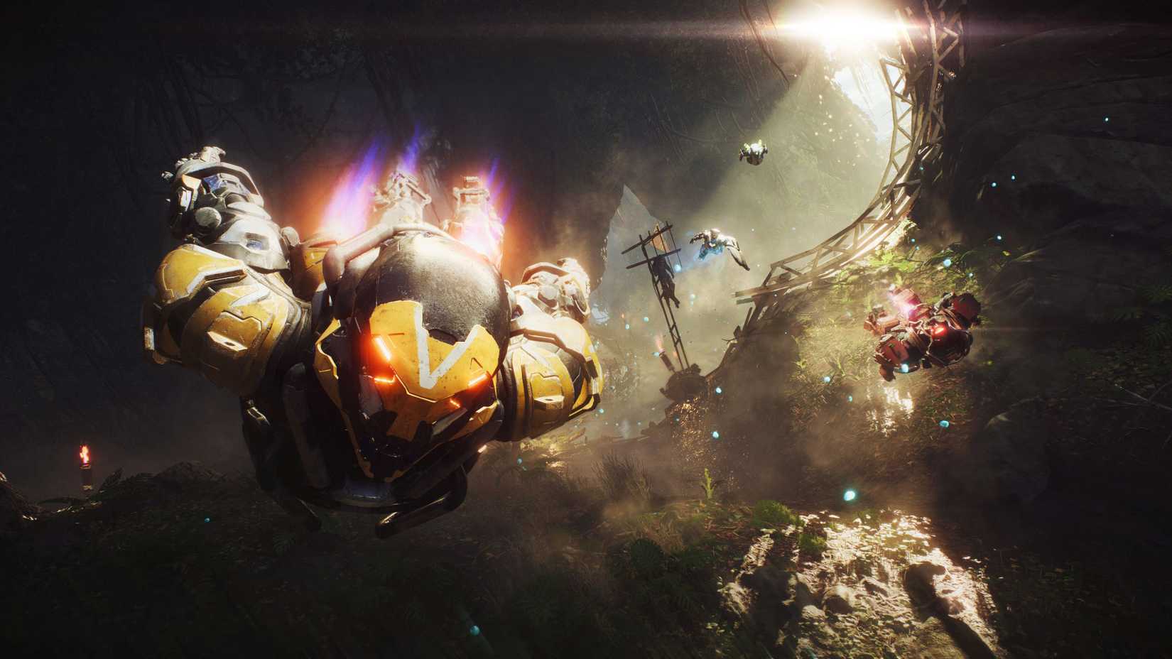 A yellow Ranger Javelin flies toward the camera alongside three other Javelins through a lush, overgrown ruin in BioWare's Anthem