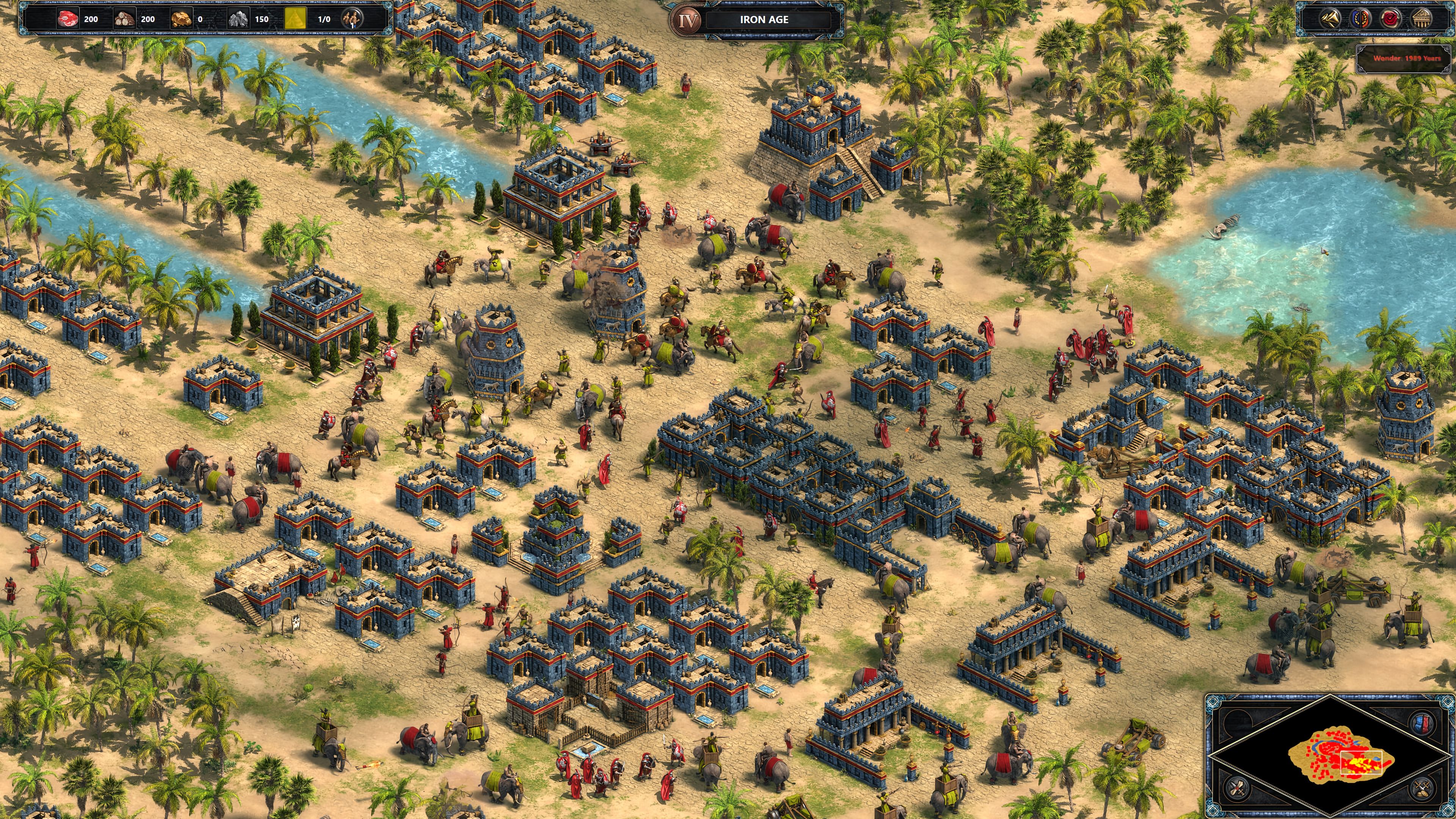 Rival fleets engage in a naval battle off the coast of an Asian settlement in Age of Empires Definitive Edition