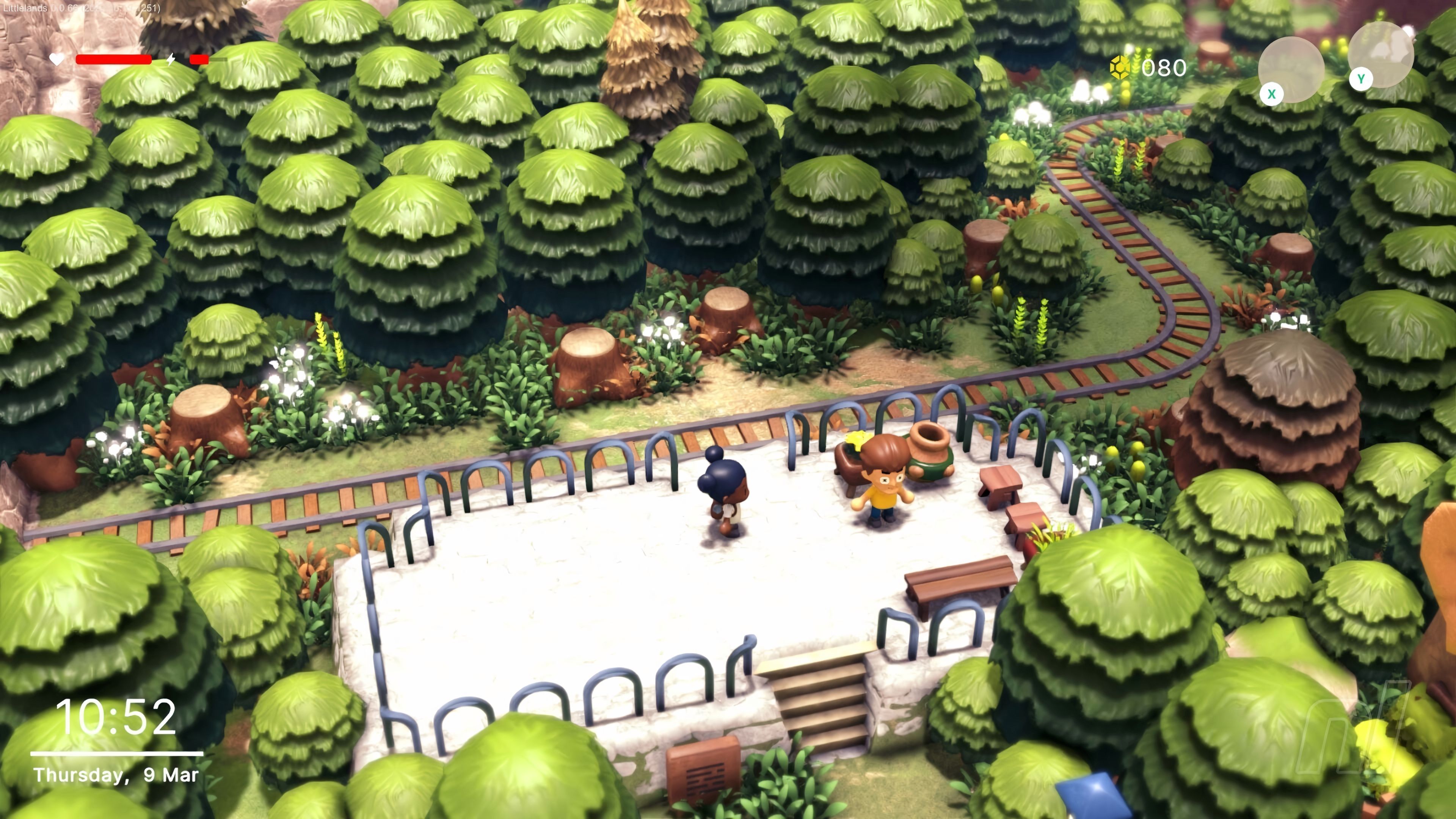 Two characters stand beside railway tracks in a lush forest in Littlelands