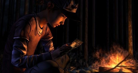 'Clementine' looks at a photo of Lee in 'The Walking Dead'