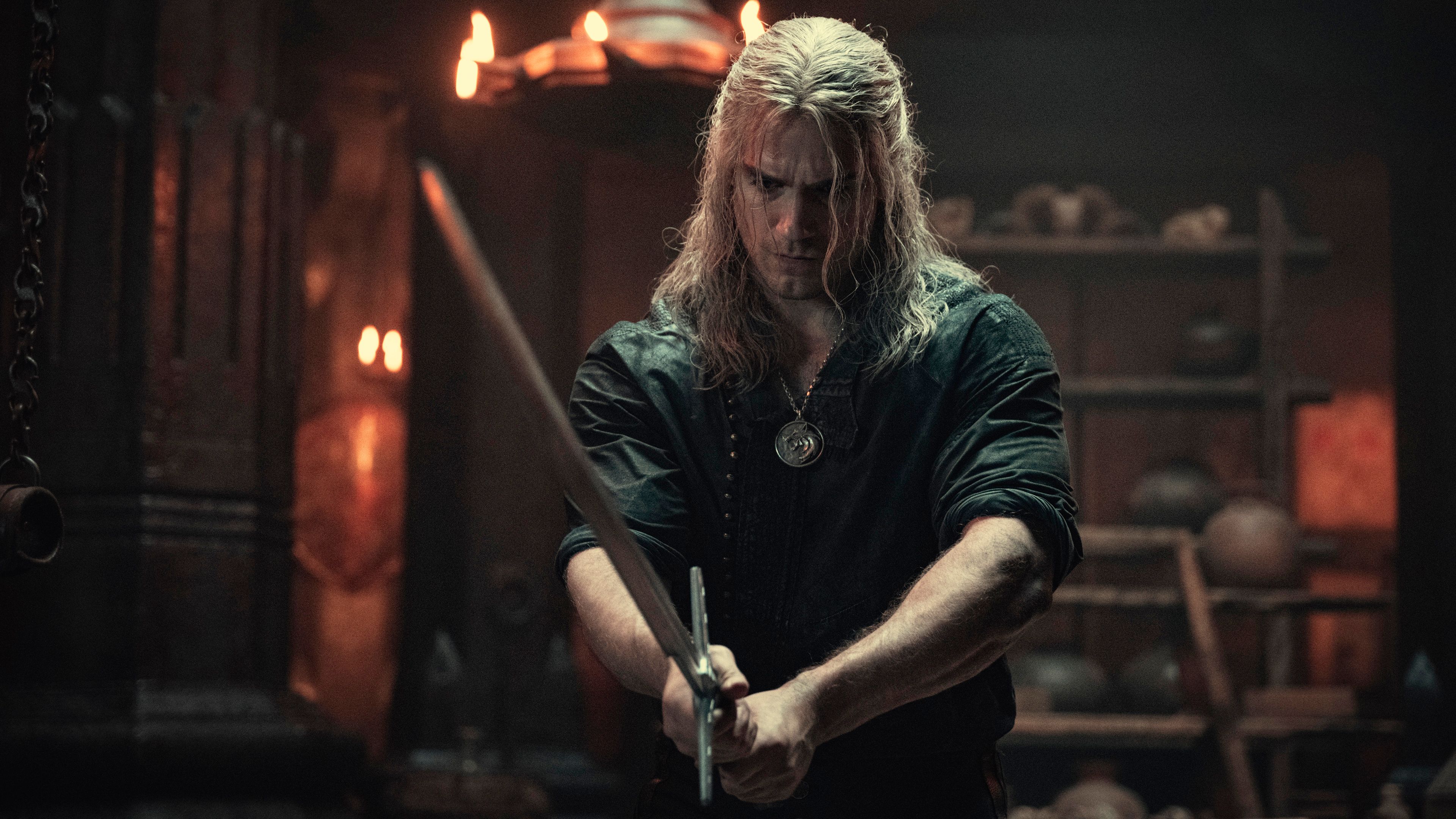 henry-cavill-as-geralt-looking-serious-and-holding-a-sword-in-the-witcher-season-2.jpg
