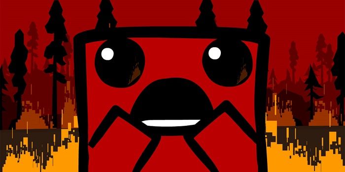 Super Meat Boy witha  shocked expression on his face as the forest burns in the background.