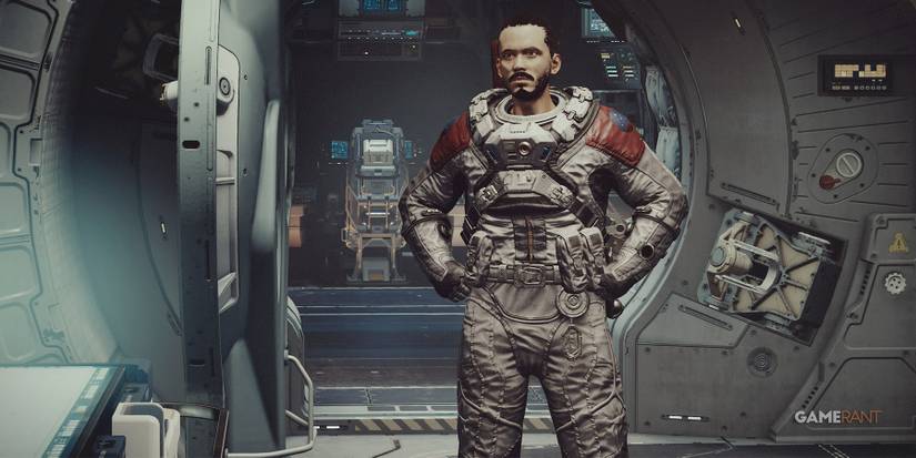 Starfield protagonist in space suit with hands on hips inside ship