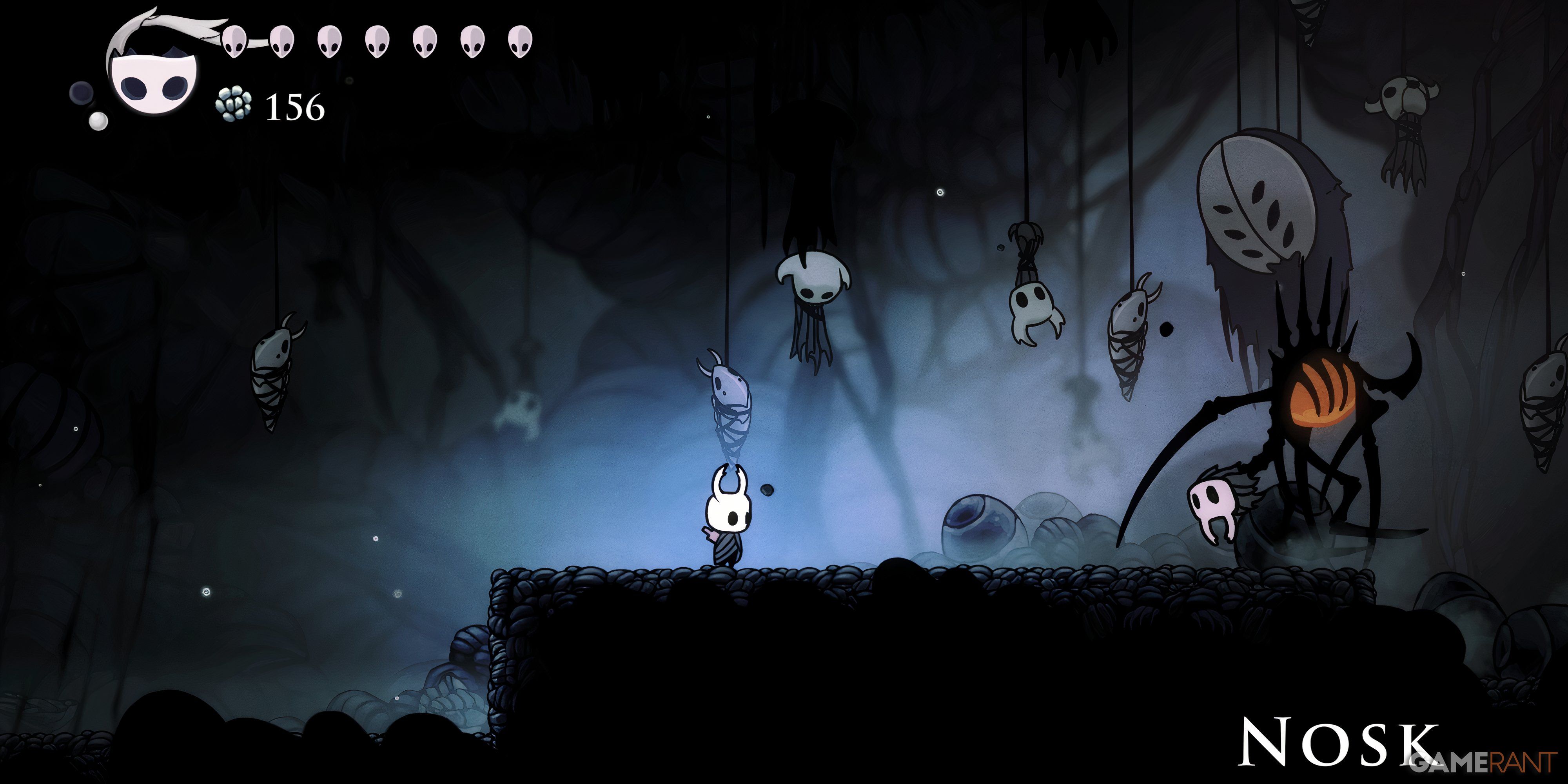 Hollow Knight: 13 Hardest Bosses, Ranked The Knight is attacked by Nosk with prey hanging from the ceiling behind