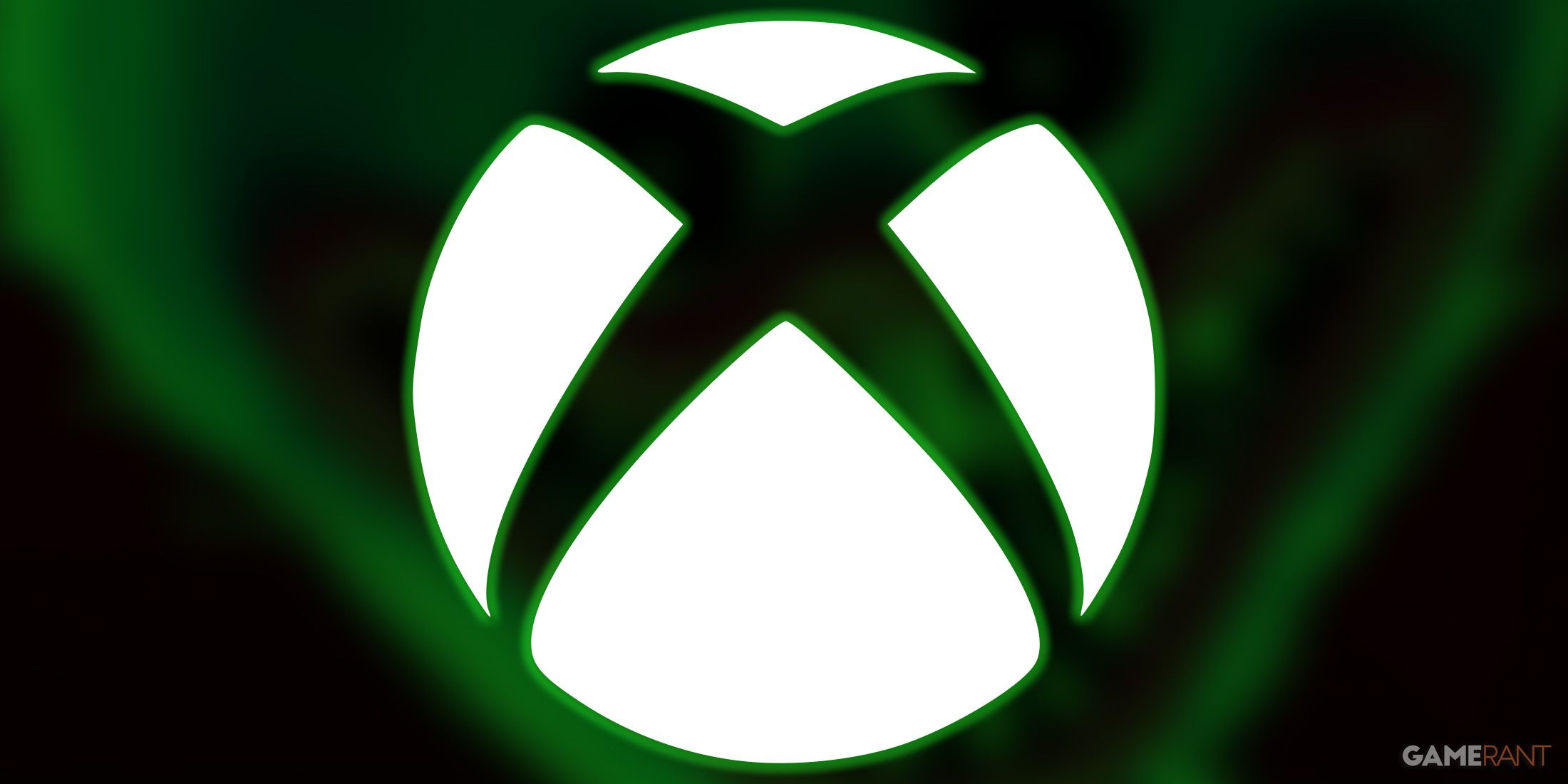 white Xbox logo submark with green outer glow on blurred Poppy Playtime promo monster key art