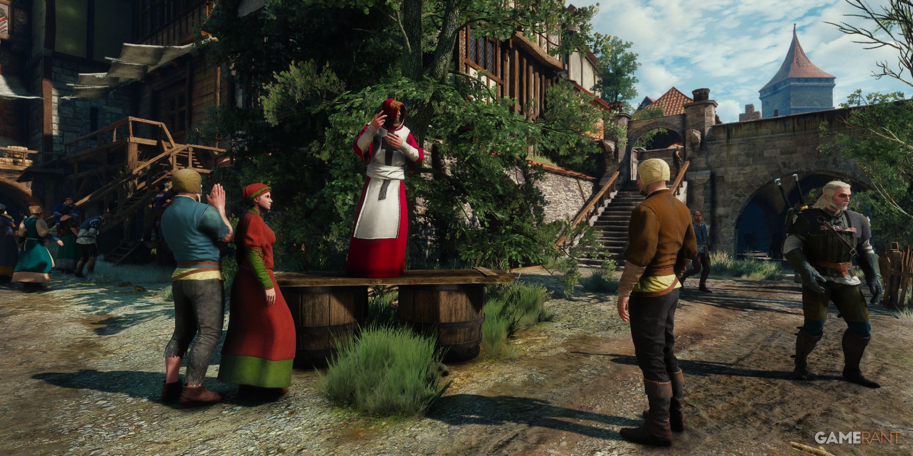 A preacher addressing townsfolk near a staircase in Novigrad in The Witcher 3