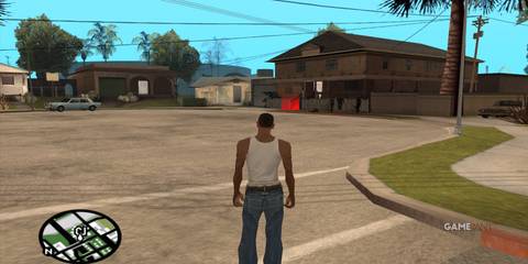 CJ standing in Grove Street with houses and cars in Los Santos in GTA San Andreas